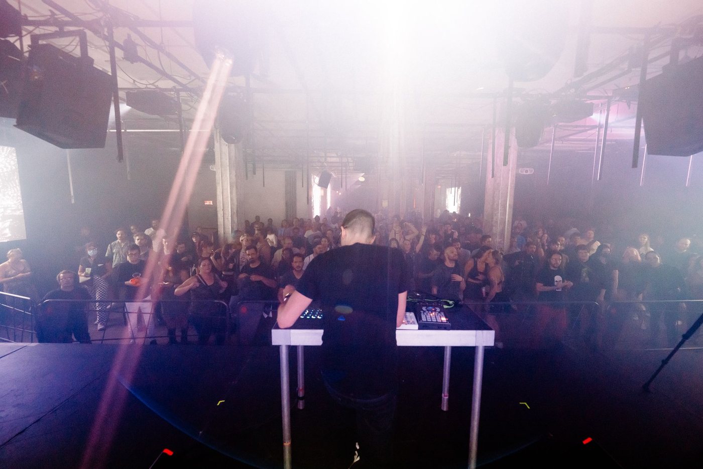 Parts Project performing to a full room, projections behind the stage